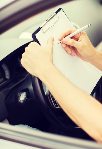 A person pointing at a car contract, highlighting a line item labeled 