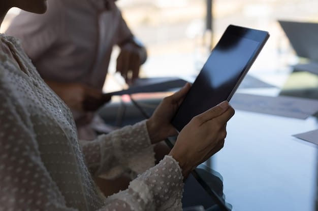 A close-up shot of a person researching car models on a tablet, the screen displaying various vehicle specifications, fuel efficiency ratings, and customer reviews.