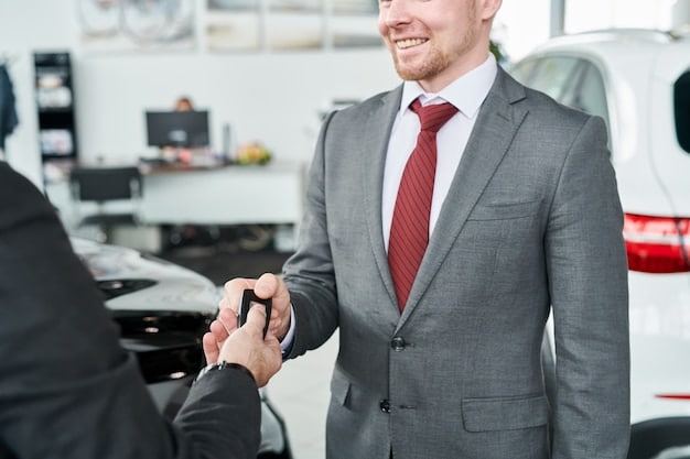 A close-up shot of a person's hand confidently shaking hands with a car salesperson over a dealership desk, symbolizing a successful car negotiation.