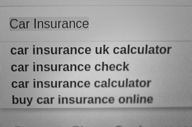 Close-up shot of a laptop screen displaying a vehicle history report, with key sections highlighted, such as accident history and title status.