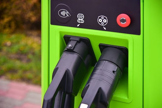 Close-up of a car's charging port with an electric vehicle charging cable plugged in, displaying the green charging light.