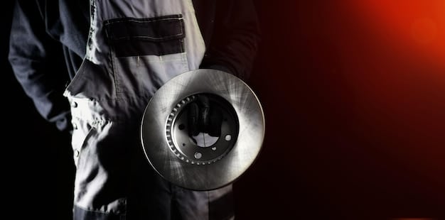 A close-up image of a mechanic pointing to a worn-out brake rotor during a pre-purchase inspection, illustrating the importance of professional evaluation.