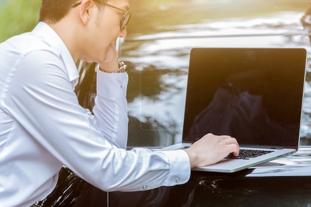 A person sitting at a desk, working on a laptop, researching different car models and comparing specifications on various automotive websites. They have a notebook and pen beside them, taking notes.