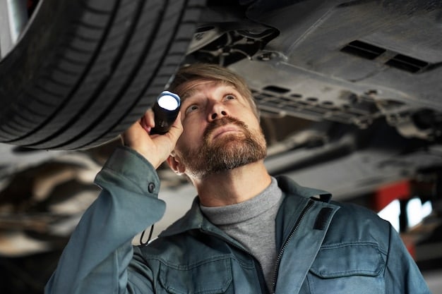 A mechanic inspecting the engine of a used car with a flashlight. He is checking different parts of the engine, while the car is in an auto repair shop.