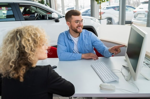 Inside a dealership with a salesperson explaining incentive options to a customer.
