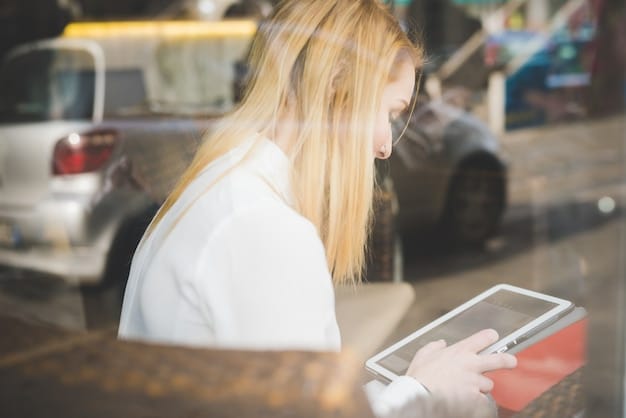A person reviewing a car history report on a tablet with a car dealership in the blurred background.