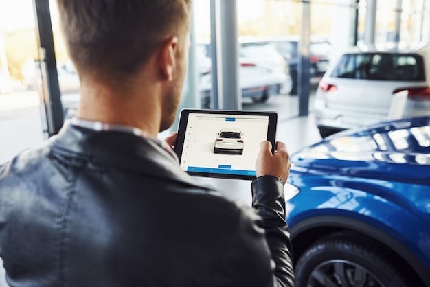 A person pointing at a tablet. The tablet screen displays information about car rebates and incentives. The background is a car dealership setting, with new cars visible.