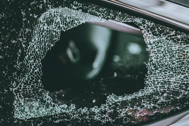 A crashed car with visible damage to the front sensors and camera system, highlighting the potential high cost of repairing advanced safety technology after an accident.