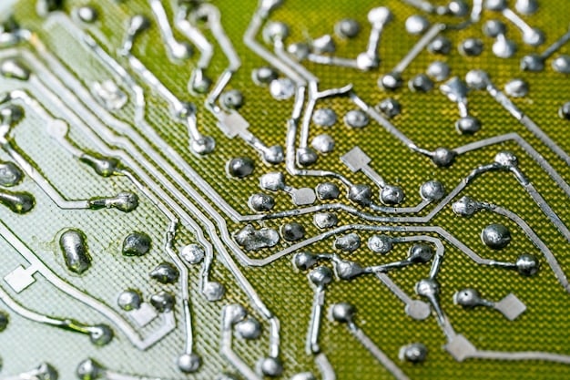 Close-up image showing a semiconductor chip with intricate circuits, highlighting the complexity and essential nature of the technology for automotive production.