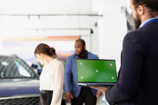 A group of auto dealership staff participating in a training session focused on electric vehicles, with a trainer demonstrating EV technology using a demonstration model.