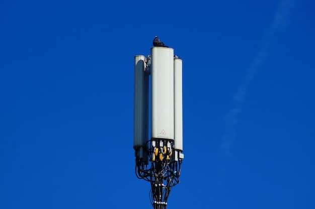 A close-up shot of a 5G antenna mounted on a street pole in a modern urban environment, with autonomous vehicles driving by in the background. The image highlights the infrastructure supporting 5G connectivity for AVs.