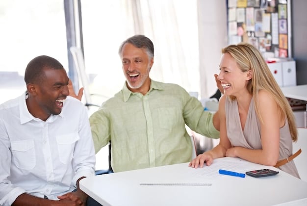 An insurance agent sitting at a desk, smiling and engaged in a conversation with a young couple. The agent is pointing at a tablet displaying insurance policy options with clear labels for EV coverage.  The setting is a modern, well-lit office, conveying trust and professionalism.
