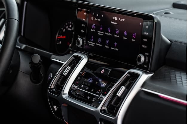 Wide shot of the 2025 Nissan Rogue's interior, showcasing the central infotainment screen displaying a navigation map, along with the digital instrument cluster behind the steering wheel. Highlight the modern and tech-focused design of the cabin.