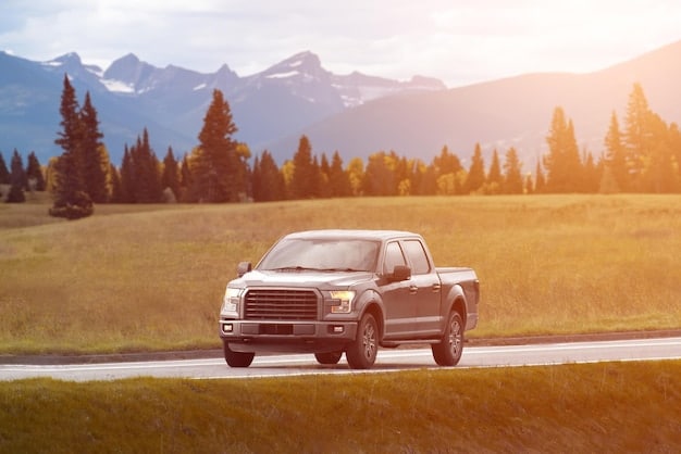 The 2025 Ram 1500 driving down a scenic highway, showcasing its smooth lines and confident stance on the road.