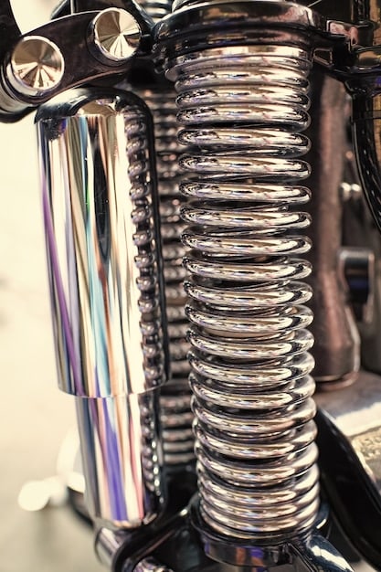 Close-up of the 2025 Chevrolet Silverado 1500’s rear suspension, showcasing the updated components designed for improved ride quality and increased towing stability. The image focuses on the shocks, leaf springs, and rear axle.