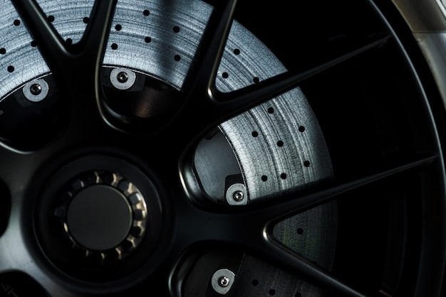 A close-up shot of the 2025 Porsche 911's wheels and brake calipers, highlighting the high-performance braking system and the intricate design of the wheels.
