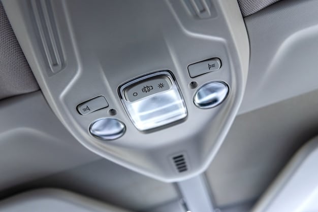 Interior shot of the 2025 Hyundai Kona Electric, focusing on the dashboard and infotainment system. The display shows a navigation map with real-time traffic updates. The materials appear premium with stitched leather details and ambient lighting.