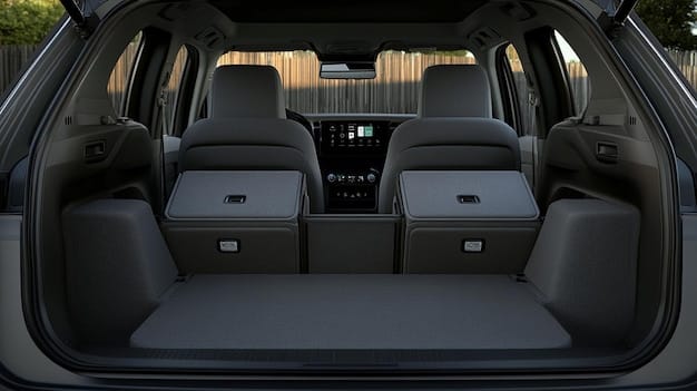 The spacious interior of a 2025 Kia Telluride, focusing on the second-row captain's chairs and the rear entertainment system. The seats are leather, and the interior is well-lit.