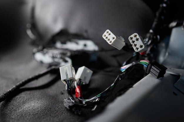 A close-up shot of the 2025 Ram 1500's trailer hitch, showing its rugged construction and integrated wiring harness for trailer connections. Focus on the durability and design of the hitch.