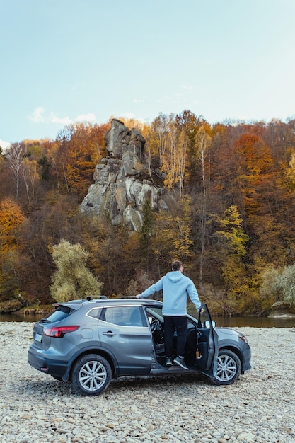 The 2025 Cadillac Escalade driving on a scenic mountain road, showcasing its smooth handling and powerful presence.