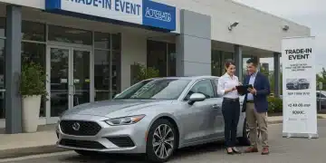 Modern silver car in front of dealership, customer discussing trade-in with employee