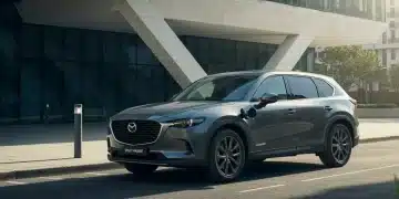 2026 Mazda CX-90 PHEV charging in a vibrant urban environment, showcasing its modern design.